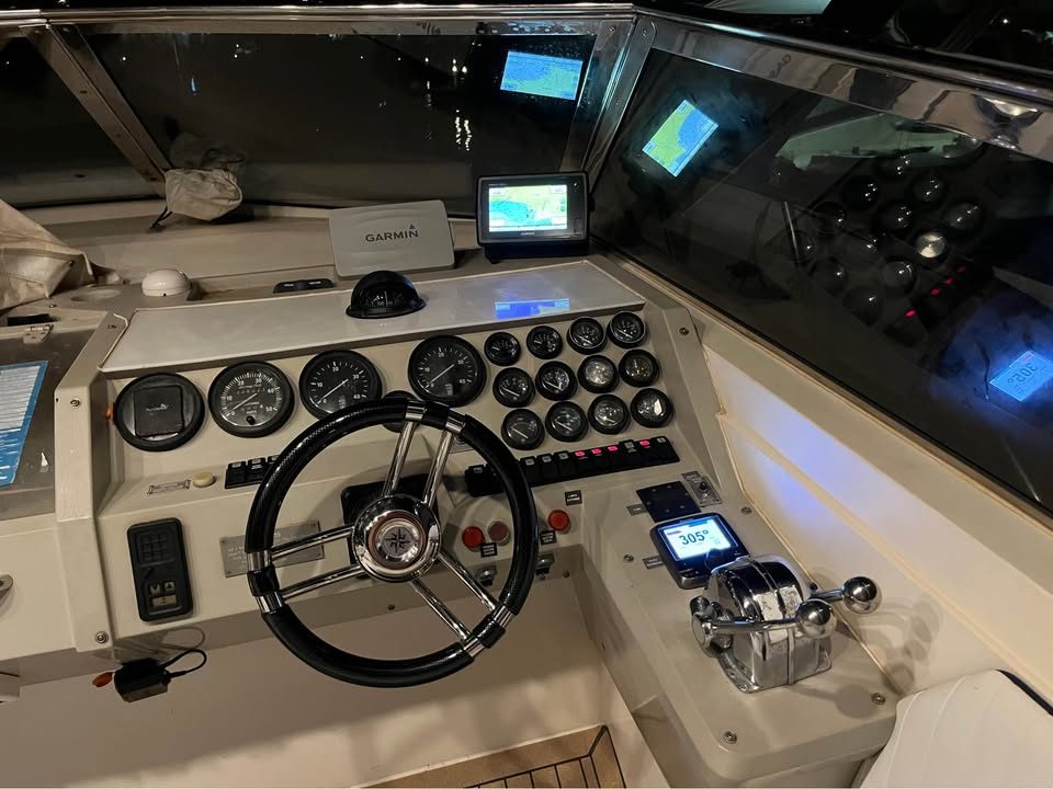 Sunseeker cockpit with helm, Garmin GPS, and engine controls